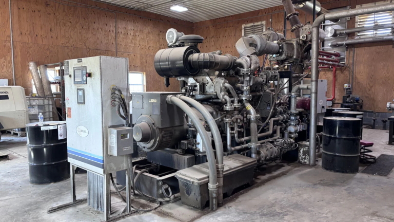 A large metal generator converts methane from an anaerobic digester into electricity.
