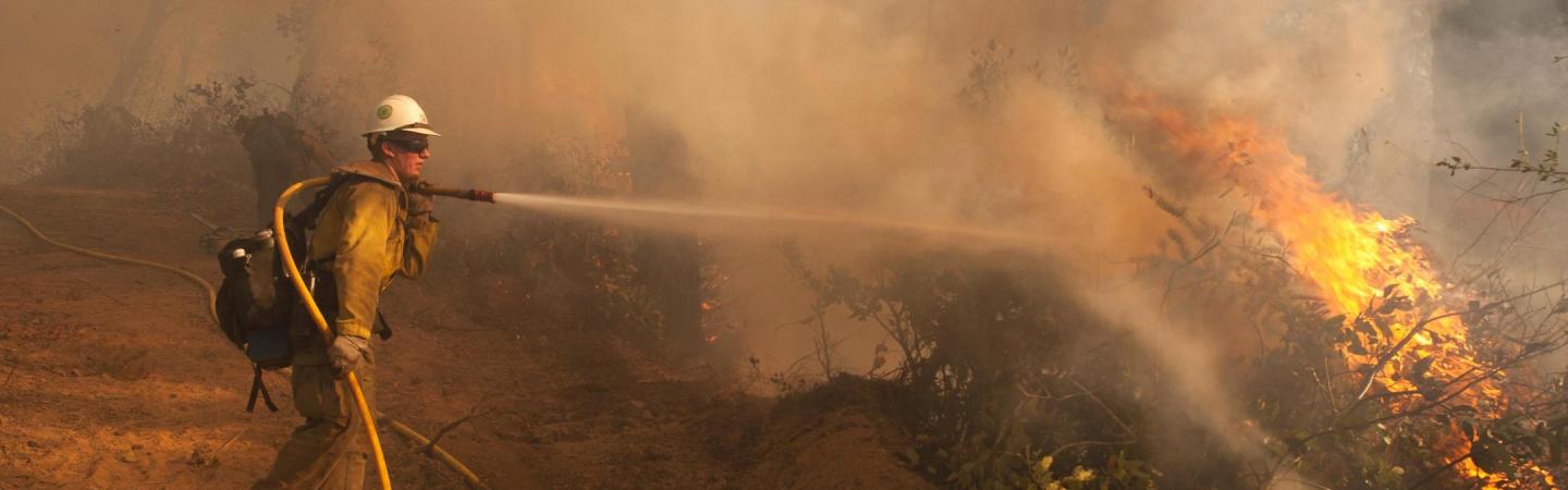 firefighter battling a wildfire
