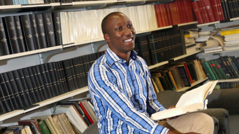 Jimmy Gasore in front of book shelves