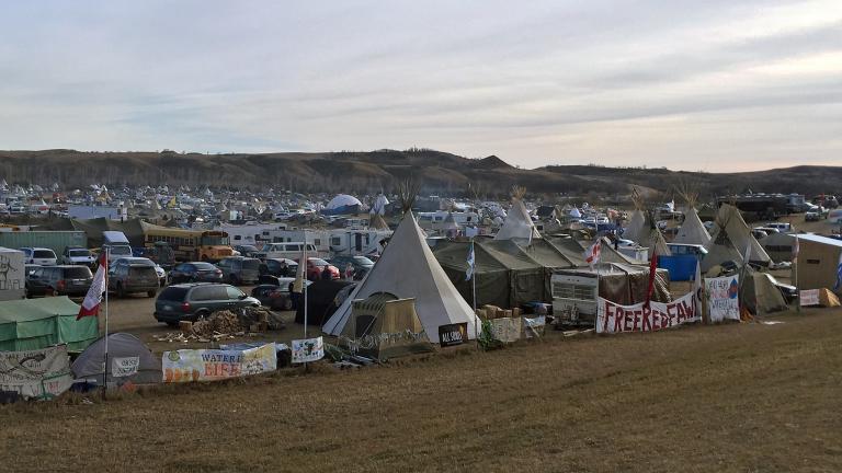 Photo of large outdoor encampment in rolling hills.