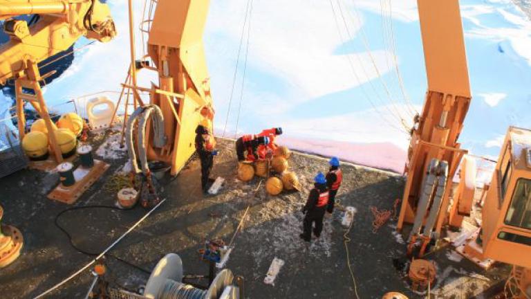Scientists working on deck of research vessel