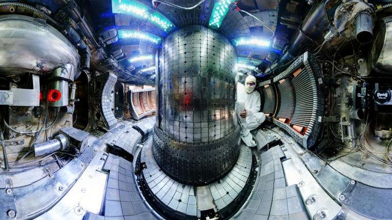The interior of the fusion experiment Alcator C-Mod at MIT recently broke the plasma pressure record for a magnetic fusion device. The interior of the donut-shaped device confines plasma hotter than the interior of the sun, using high magnetic fields. Postdoc Ted Golfinopoulos, shown here, is performing maintenance between plasma campaigns. Credits:Photo: Bob Mumgaard/Plasma Science and Fusion Center