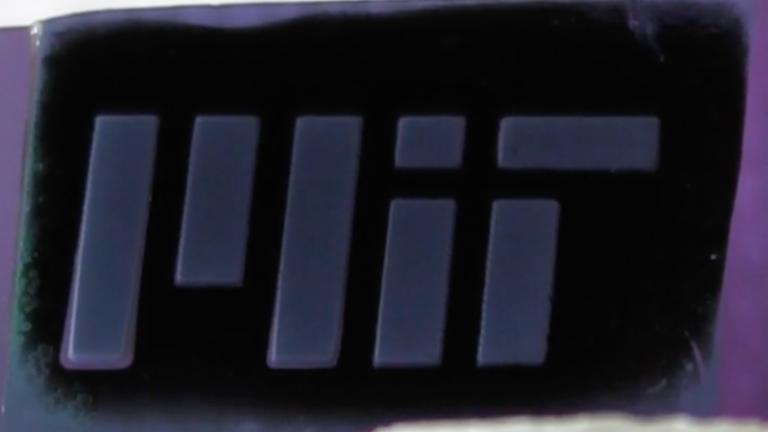 MIT engineers fabricate a forest of “white graphene” nanotubes (shown here patterned as MIT) by burning away a scaffold of black carbon.
