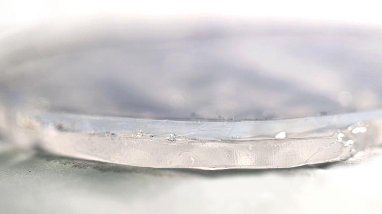 MIT researchers have developed a two-layer passive cooling system, made of hydrogel and aerogel, that can keep foods and pharmaceuticals cool for days without the need for electricity. In this photo showing a close-up of the two-layer material, the upper layer consists of aerogel and the bottom layer of hydrogel.