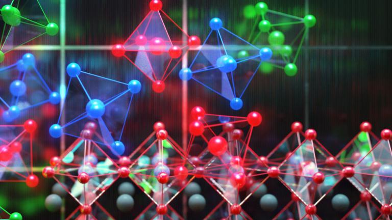 This image shows perovskite photovoltaics in the background with individual perovskite crystals shown as the colorful units. 