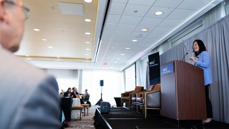 At the 2025 MIT Energy Initiative Spring Symposium, Evelyn Wang (at lectern), the MIT vice president for energy and climate, joined MITEI Director William H. Green to discuss how collaborations across campus can help solve the data center challenge.
