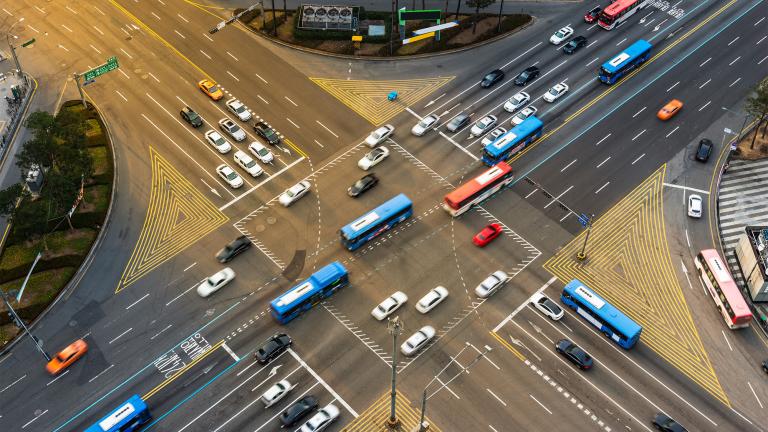 In a new study, MIT researchers demonstrate a machine-learning approach that can learn to control a fleet of autonomous vehicles as they approach and travel through a signalized intersection in a way that keeps traffic flowing smoothly.