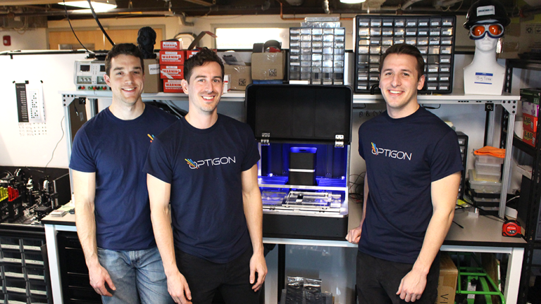 Optigon co-founders (from left to right) Brandon Motes, Dane deQuilettes, and Anthony Troupe stand with a benchtop version of the measurement tool they believe will help accelerate the pace of solar power and other clean energy products.