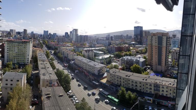 Elevated photo of city street and buildings.
