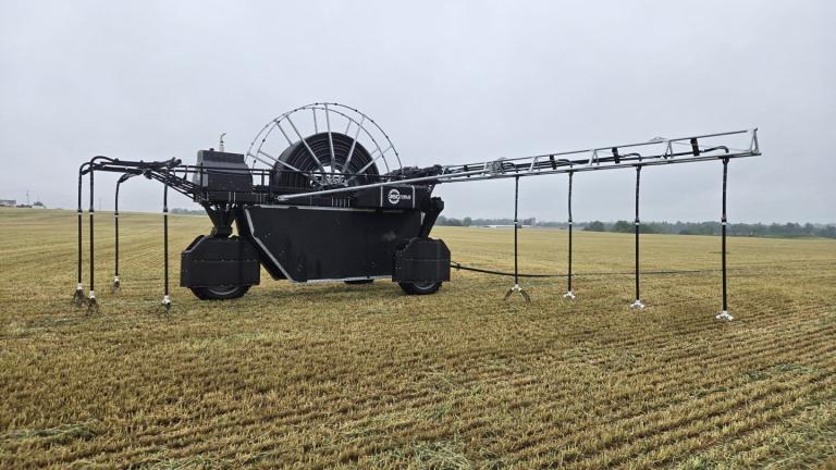 A large machine spreads manure on a field on Pennsylvania.