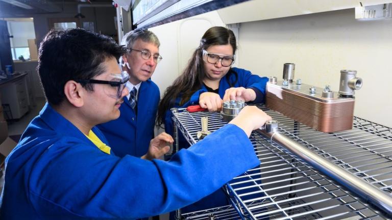 Based on a series of analytical studies, MIT chemical engineers have come up with an idea that would enable long-haul trucks to use clean-burning hydrogen in place of diesel fuel, thereby reducing their carbon emissions. Left to right: Sayandeep Biswas, William Green, and Kariana Moreno Sader are now building an experiment to test and fine-tune equipment key to their promising approach. 