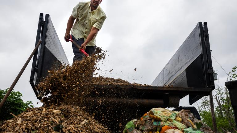 Leo Brito, Founder of Zero Waste Houston, dumps wood chips during a composting class.