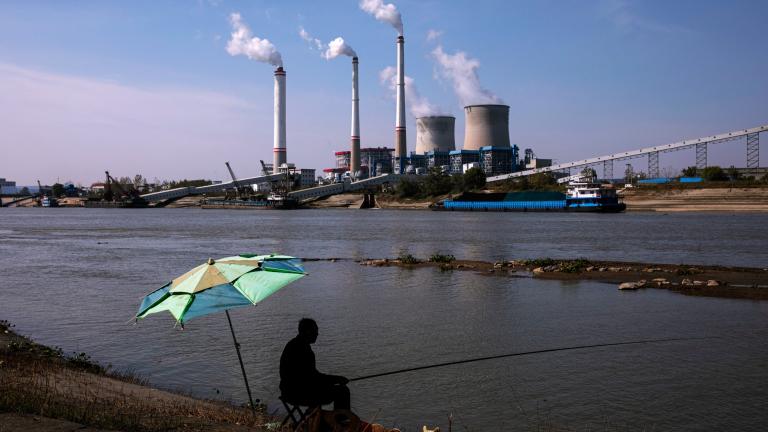 Residents fish near a coal plant in Hanchuan, Hubei province, China.