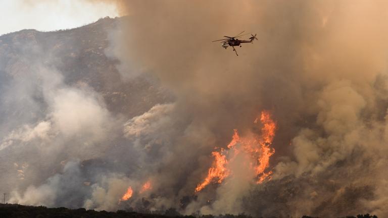 Helicopters drop water and fire retardant on a wildfire in Southern California.