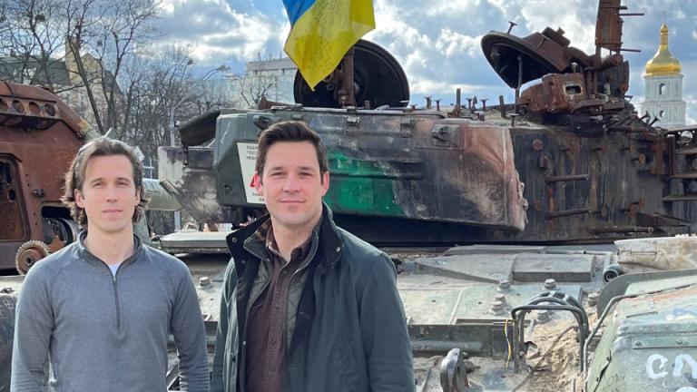 Ian Miller SM ’18 (left) with his colleague Evan Platt SM ’20 in Kyiv's Mykhailivs'ka Square. Alongside Ukrainians, they co-founded Zero Line, a nonprofit delivering medical aid, vehicles, and equipment to Ukrainians on the front lines. 