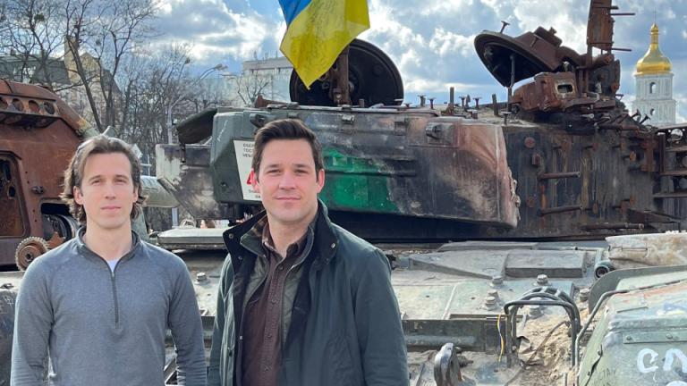 Ian Miller SM ’18 (left) with his colleague Evan Platt SM ’20 in Kyiv's Mykhailivs'ka Square. Alongside Ukrainians, they co-founded Zero Line, a nonprofit delivering medical aid, vehicles, and equipment to Ukrainians on the front lines.