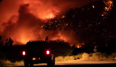 Car driving through forest fire
