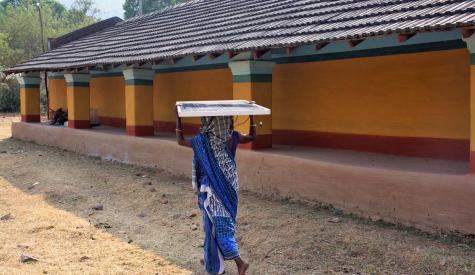 An Indian woman carries a solar panel developed by Khethworks, the first startup to emerge from the Tata Center. 