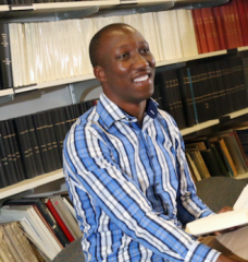 Jimmy Gasore in front of book shelves