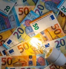 Image of a lightbulb against a pile of Euros