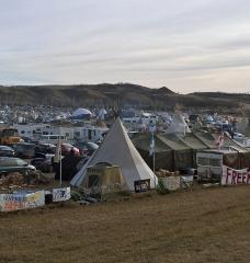 Photo of large outdoor encampment in rolling hills.