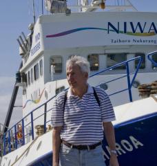 Dean Roemmich in front of a boat in New Zealand 