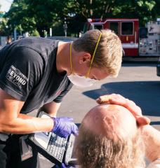 A paramedic treats a man experiencing heat exposure during the heatwave in Salem, Ore.