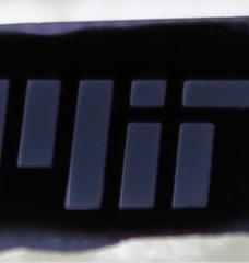 MIT engineers fabricate a forest of “white graphene” nanotubes (shown here patterned as MIT) by burning away a scaffold of black carbon. 