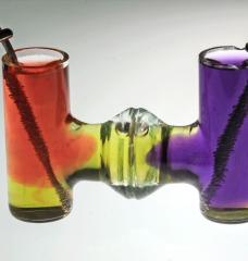 In a demonstration of the basic chemical reactions used in the new process, electrolysis takes place in neutral water. Dyes show how acid (pink) and base (purple) are produced at the positive and negative electrodes. A variation of this process can be used to convert calcium carbonate (CaCO3) into calcium hydroxide (Ca(OH)2), which can then be used to make Portland cement without producing any greenhouse gas emissions. Cement production currently causes 8 percent of global carbon emissions.