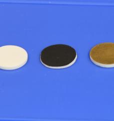 These discs were used for testing the researchers’ processing method for solid-electrolyte batteries. On the left, a sample of the solid electrolyte itself, a material known as LLPO. At center, the same material coated with the cathode material used in their tests. At right, the LLPO material with a coating of gold, used to facilitate measuring its electrical properties.