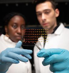 MIT graduate students Eunice Aissi, left, and Alexander Siemenn, have developed a technique that automatically analyzes visual features in printed samples (pictured) to quickly determine key properties of new and promising semiconducting materials.