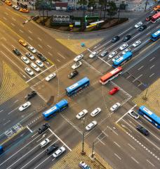 In a new study, MIT researchers demonstrate a machine-learning approach that can learn to control a fleet of autonomous vehicles as they approach and travel through a signalized intersection in a way that keeps traffic flowing smoothly.