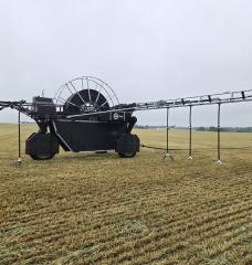 A large machine spreads manure on a field on Pennsylvania.