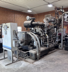 A large metal generator converts methane from an anaerobic digester into electricity. 