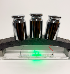 An electron-conducting carbon concrete (ec³)-based arch structure integrates supercapacitor electrodes for dual functionality. The prototype demonstrates both structural load bearing and the ability to power an LED, with the light’s intensity varying under applied load, highlighting the potential for real-time structural health monitoring via the supercapacitor.