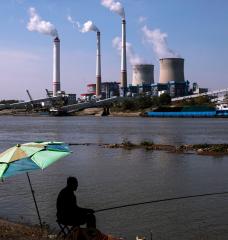 Residents fish near a coal plant in Hanchuan, Hubei province, China.