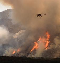 Helicopters drop water and fire retardant on a wildfire in Southern California. 
