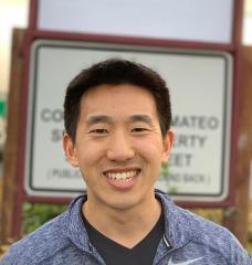 Joel Jean PhD ’17, co-founder of Swift Solar, stands in front of the company’s sign at its permanent location in San Carlos, California.