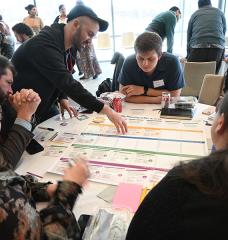 Living Climate Futures Symposium participants worked together to identify potential pros, cons, and trade-offs of allowing a data center to be built in a fictitious community. 