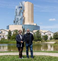 Maja Hoffmann (left), founder and president of the LUMA Foundation, and Hashim Sarkis, dean of the MIT School of Architecture and Planning, at LUMA Arles in the Parc des Ateliers in France. This 27-acre interdisciplinary campus is an experimental site of exhibitions, artists’ residencies, research laboratories, and educational programs that includes The Tower, a multipurpose space designed by Frank Gehry, seen here amid 19th-century factory buildings.